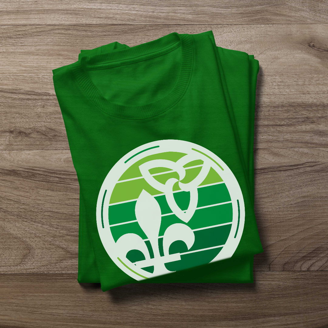 Folded Retro-Inspired Franco-Ontarian Shirt on a wooden background, featuring a design with the trillium and fleur-de-lys.