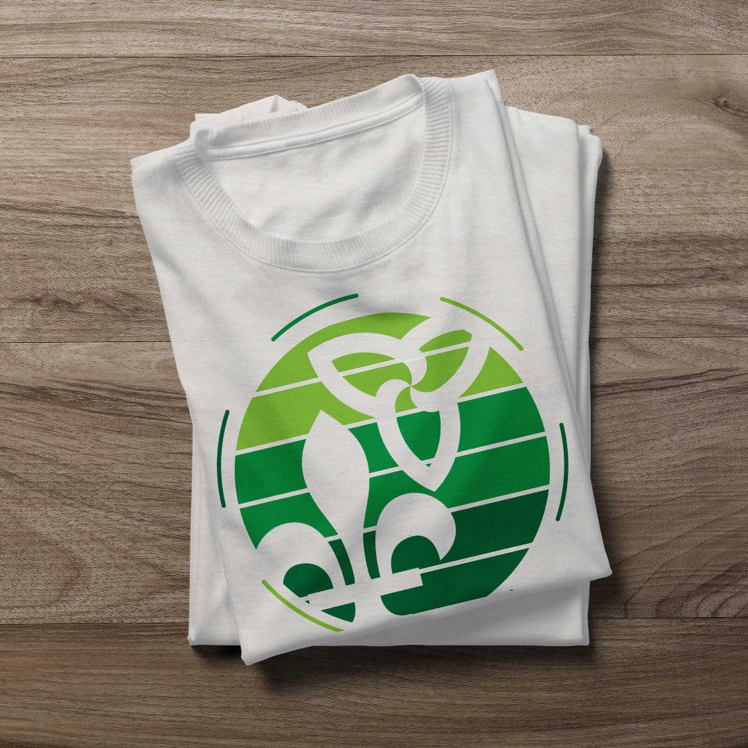 Folded Retro-Inspired Franco-Ontarian Shirt on a wooden background, featuring a design with the trillium and fleur-de-lys.