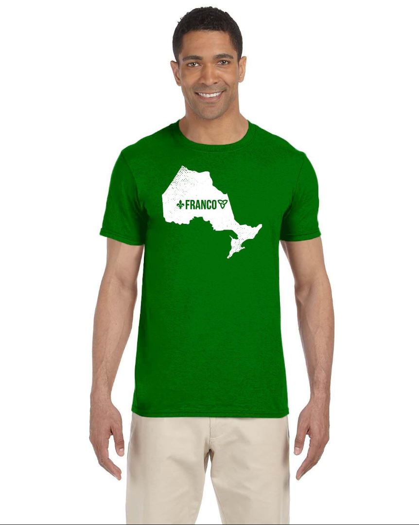 Smiling Black man wearing khakis and a Franco-Ontarian shirt with the silhouette of Ontario, the word "Franco," and the iconic trillium and fleur-de-lys design, standing against a white background.