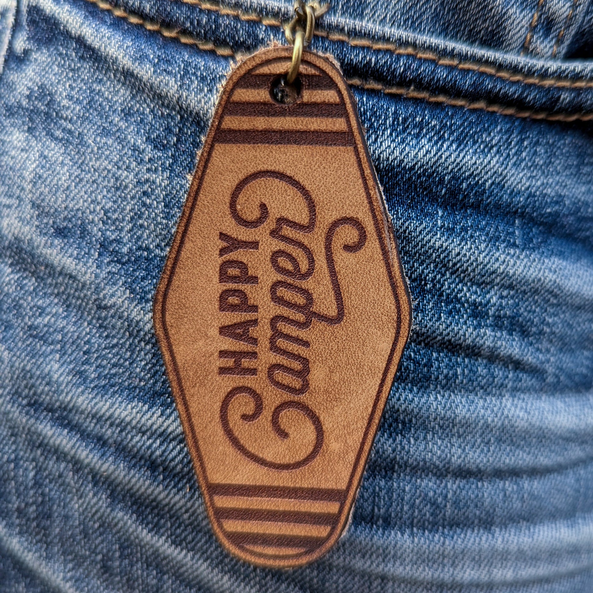 Leather Keychain cut and engraved to look like a vintage motel key with Happy Camper engraved on it.