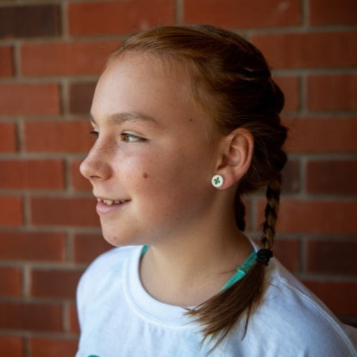 Young girl profile showing fleur de lys earring from the Franco Ontarien earrings from Cabin Design Co