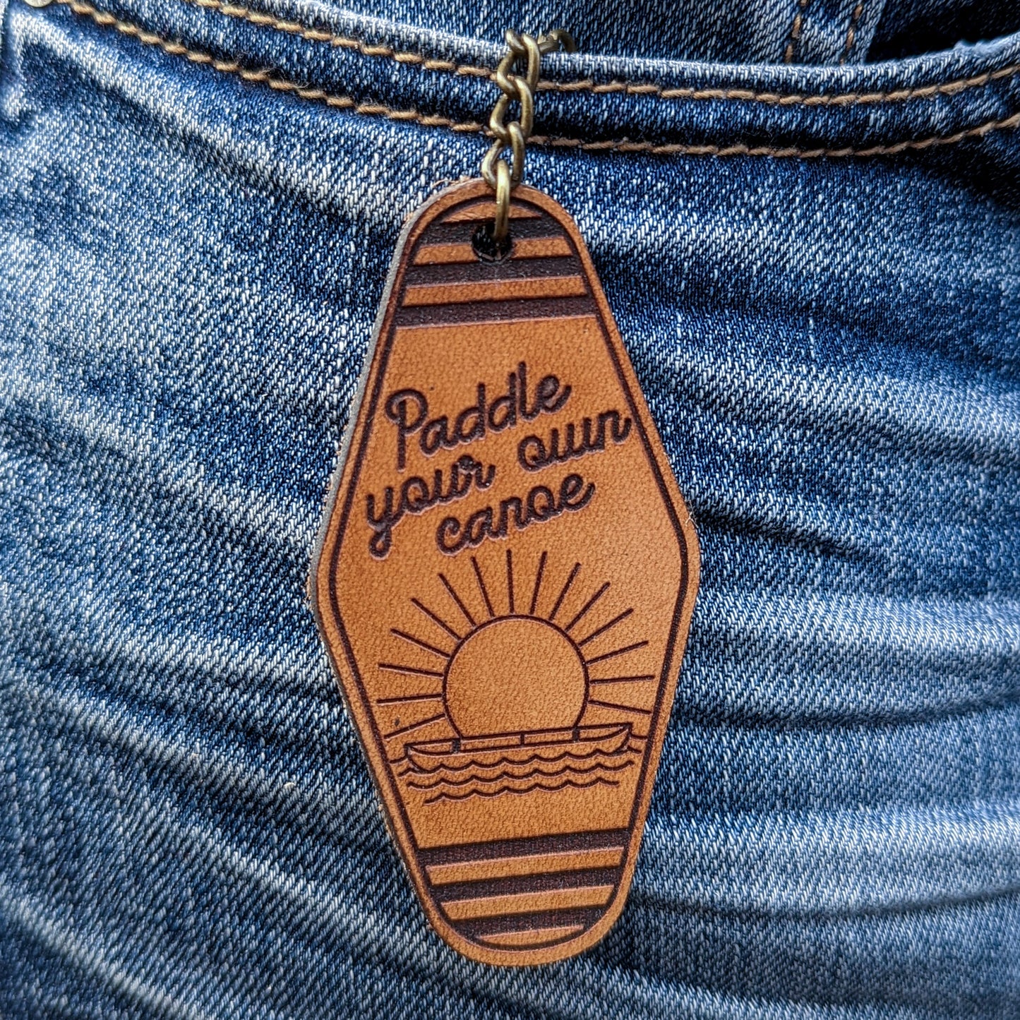 Leather Keychain cut and engraved to look like a vintage motel key with Paddle your own canoe engraved on it.